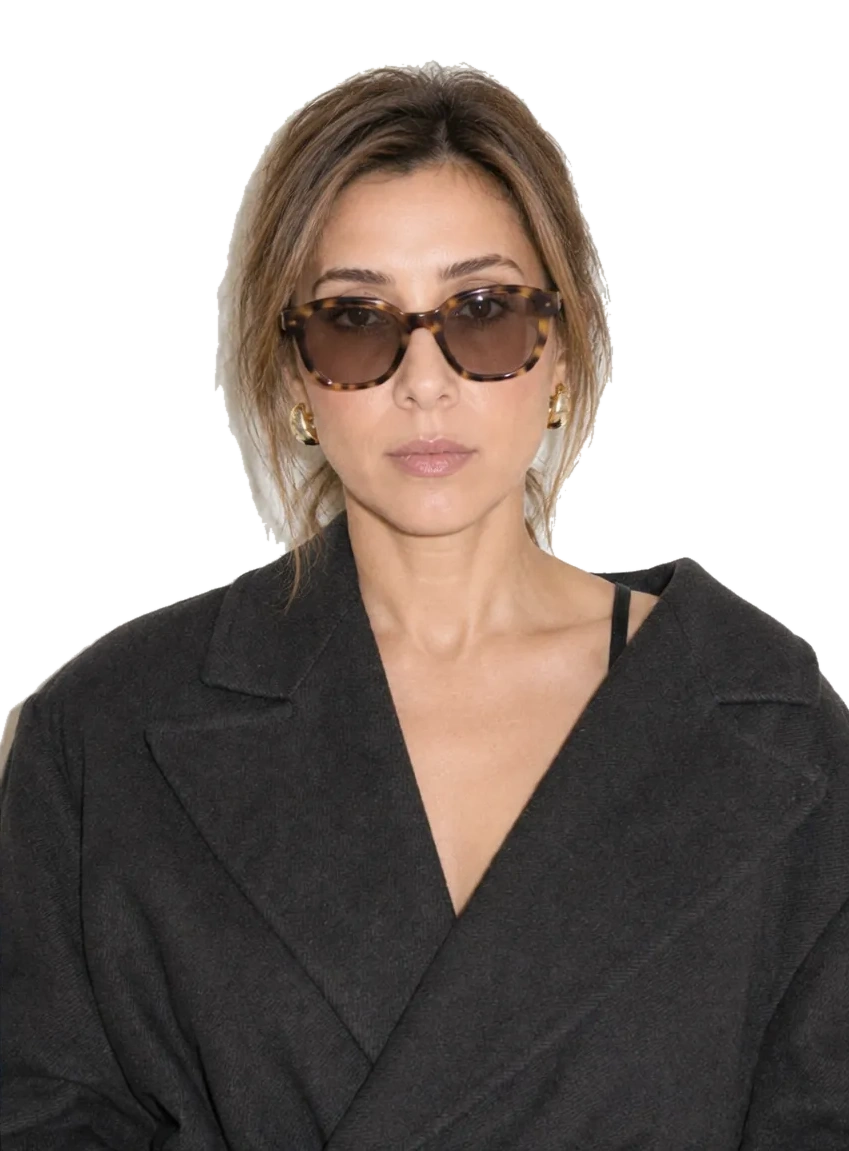 Mou Grasso in her black coat and tortoiseshell sunglasses
